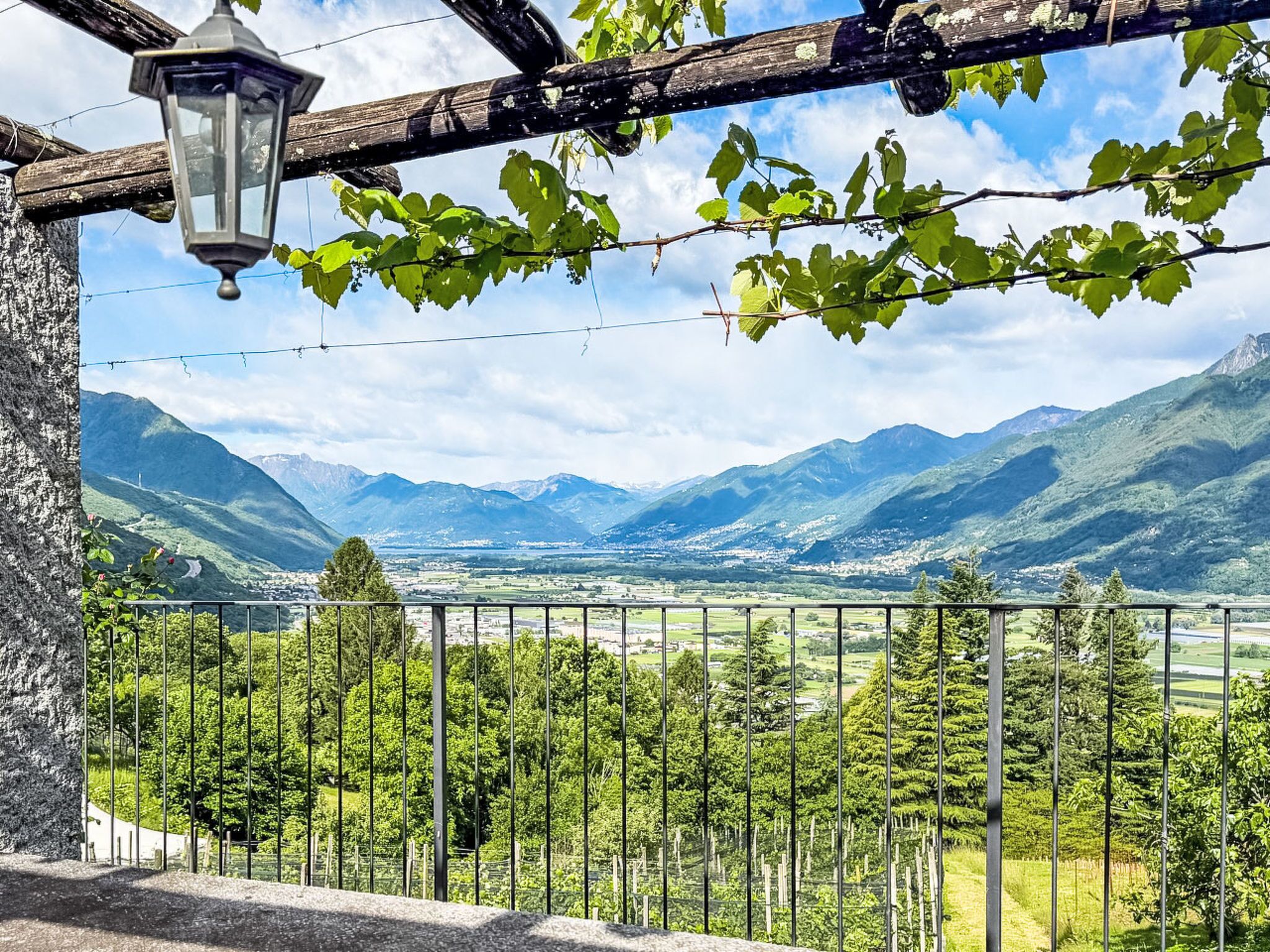 A balcony with a view of a valley and mountains.