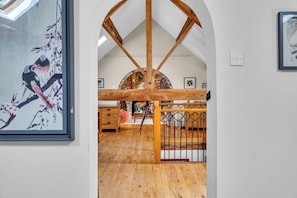 A room with wooden beams, a brick fireplace, and a wooden floor. - Oxhay Barn Luxury Stay, Sleeps 14 • Hot Tub • Gym (Newcastle Under Lyme)