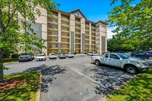 A multi-story parking garage with several cars parked.