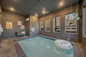 Swim in the private indoor pool, with a float ready to go and a wall of windows looking out to the trees. - Sleeps 16, Private Heated Indoor Pool, Theater, 1 Mi to Downtown Gatlinburg (Gatlinburg)