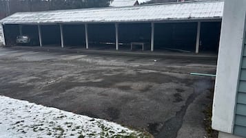 A large, open building with multiple covered parking bays and a flat roof.