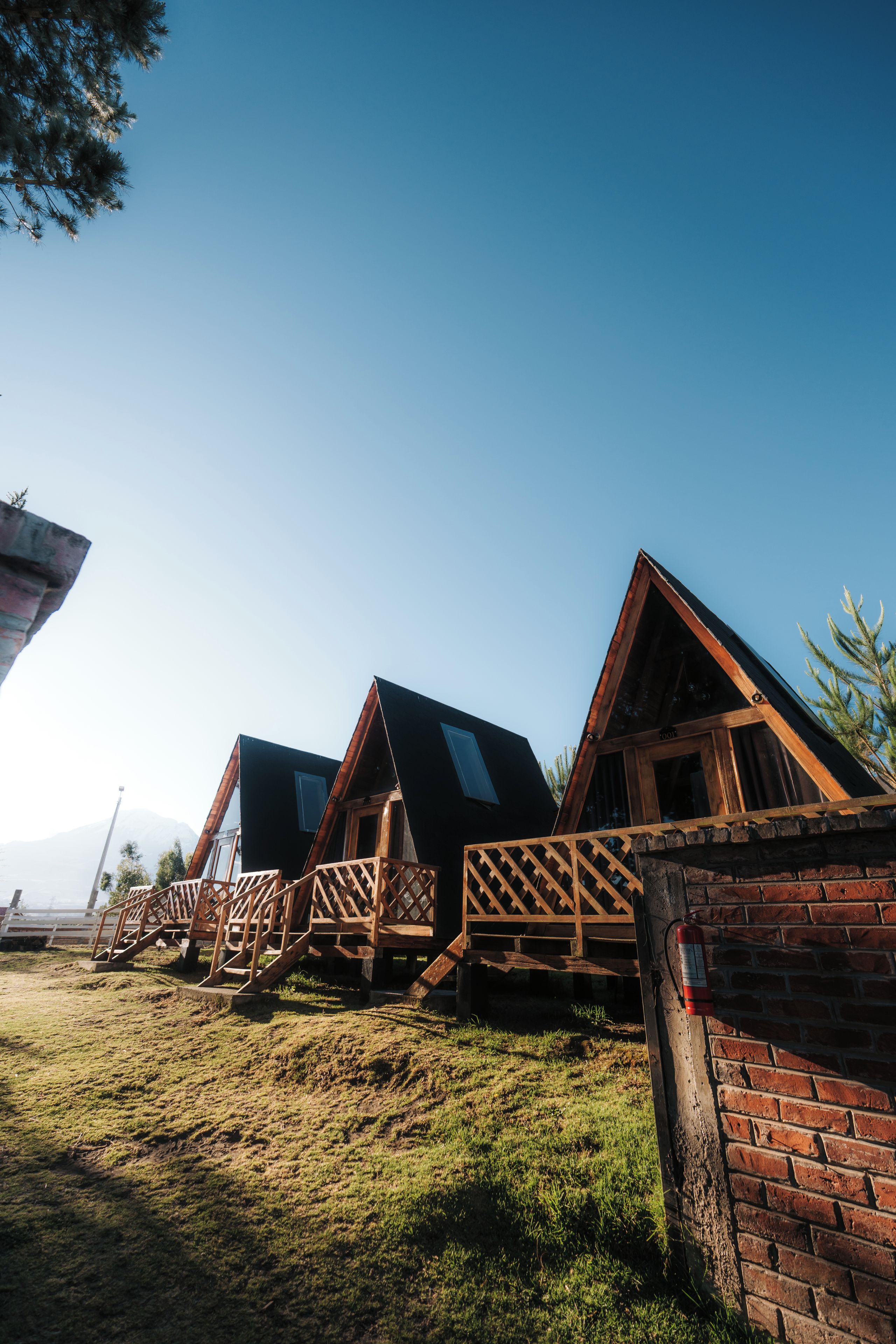 Una fila di cabine di legno con tetti spioventi, ringhiere in legno e pareti in mattoni.