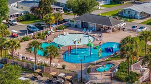 A resort with multiple swimming pools, a clubhouse, and a parking area. - Newly remodeled 3BR/2BA Oceanfront Golf Cart Village Beach House (Surfside Beach)