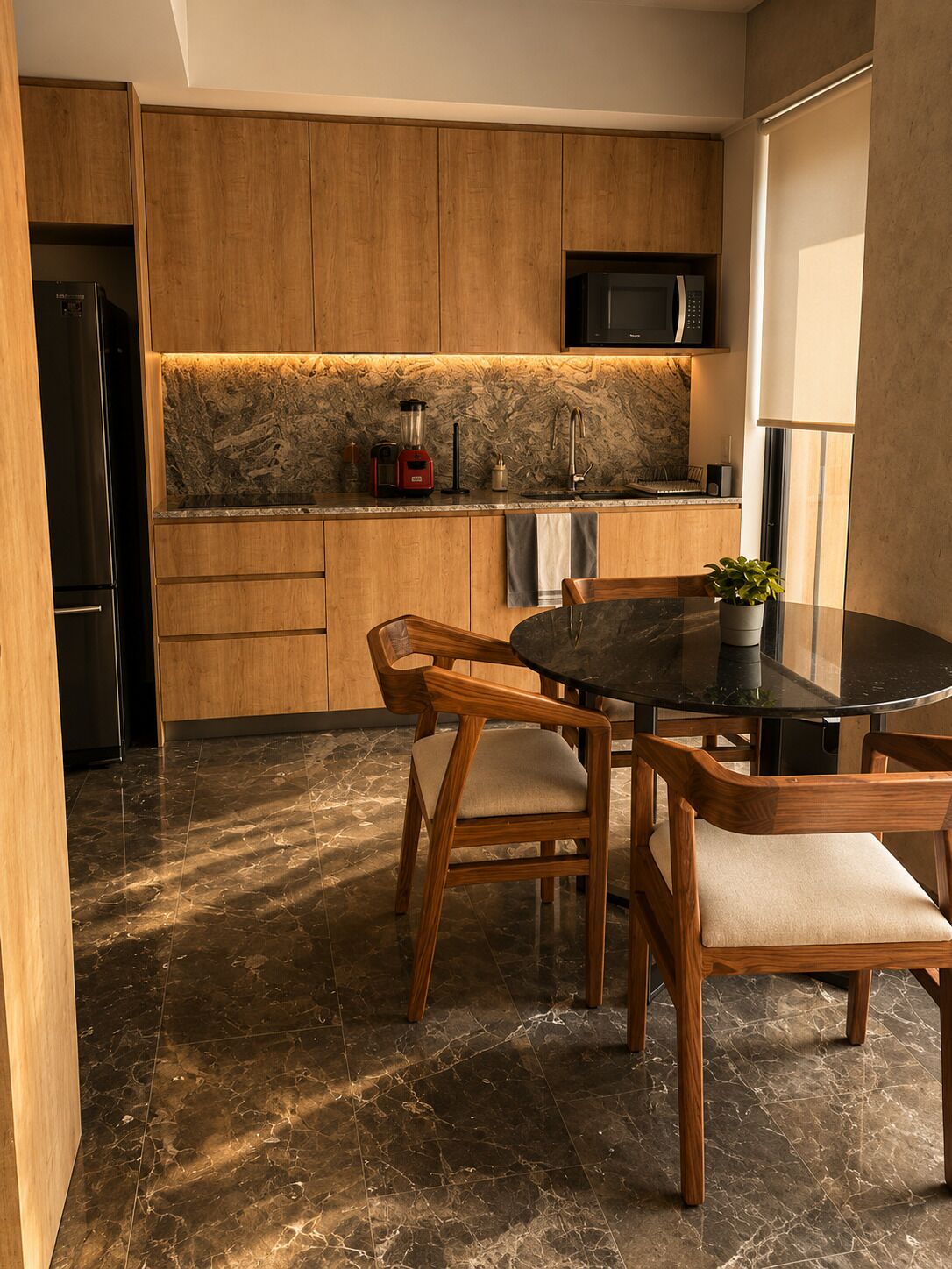 A modern kitchen with wooden cabinets, a black countertop, a built-in microwave, and a dining area with a round table and wooden chairs.