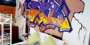 A room with a bunk bed, a mural, and a small table with a book. - Bloomfield Lodge Hotel (Blackpool)
