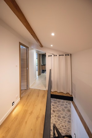 A hallway with wooden flooring, a staircase, and a shower area. - The Ostalet in Sampzon  (Sampzon)