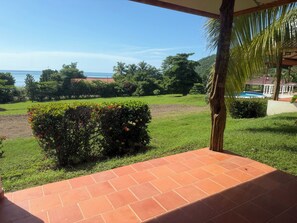 Una terraza con vistas a una piscina y follaje.