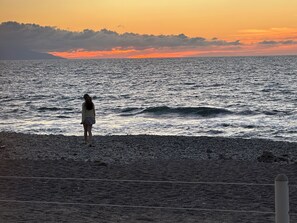 A beach scene with a person standing on the shore, facing the ocean. - Resort with 2 bedrooms and AC in serene Puerto Vallarta - sleeps 6 (Puerto Vallarta)