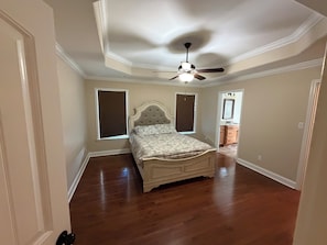 A bedroom with a bed, a ceiling fan, and a window. - 3-bedroom house in fabulous Gaffney with a spacious back yard (Gaffney)