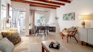 A spacious living room with a fireplace, a dining area, and a seating area with a sofa and chairs. - Holiday Home in Nerja With Sea Views & Pool (Nerja)