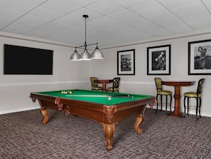 A pool table with chairs, a television, and framed pictures on the wall. - Marriott's Fairway in New Jersey 2 Bedroom Villas (Galloway)