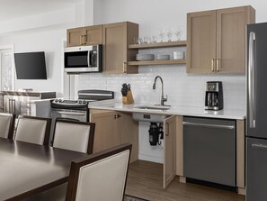 A modern kitchen with wooden cabinets, a microwave, a coffee maker, and a dishwasher. - Marriott's Fairway in New Jersey 2 Bedroom Villas (Galloway)