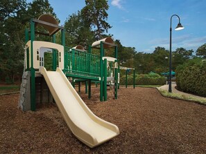 A playground with a slide, climbing structures, and a lamp post. - Marriott's Fairway in New Jersey 2 Bedroom Villas (Galloway)