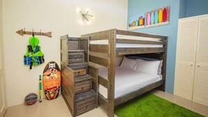 A bunk bed with a built-in desk and drawers, a green rug, and a wall with colorful artwork. - Modern 3BRVilla in Secure Draxhall Gated Community (St Ann)