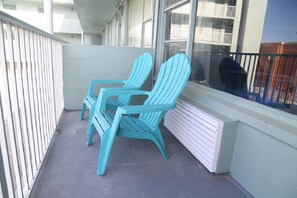 A balcony with two turquoise Adirondack chairs and a white radiator. - New Wonderful Beach Front Studio in Daytona Beach! (Daytona Beach)
