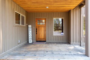 A wooden exterior with a welcome sign, a door, and a window. - NEW LISTING Sunriver Retreat w/Game Room & Patio, Near Trails (Sunriver)