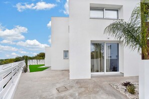 A modern building with a flat roof, a balcony with a white railing, and a small window. - Eclipse: New Private 4-Bed Villa, Central Napa (Ayia Napa)
