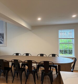 A conference room with a long table, black chairs, a window with blinds, and a ceiling light. - New listing, gorgeous home w/salt water pool in Sandwich, 
10 min from bridge!! (Sandwich)