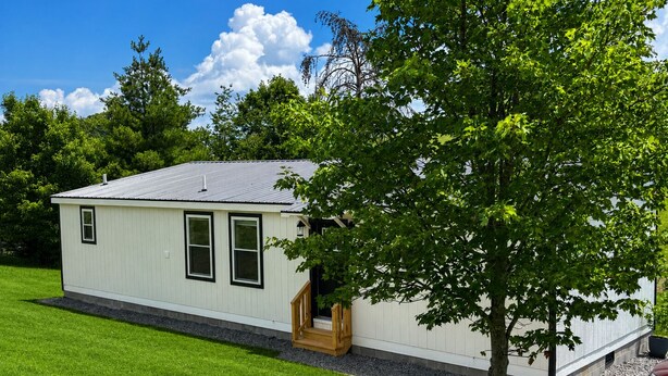 A single-story building with a flat roof, a front door, and a small porch. - Modern New Cabin in East TN. Near Cherokee Lake and 1 hr to Pigeon Forge (Bean Station)