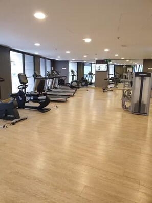 A gym with treadmills, stationary bikes, and weight machines. - 22nd Fl Damac Tower - 1 BedRoom Apt with Balcony (Amman)