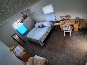 A bedroom with a bed, a desk, a chair, a ceiling fan, and a window. - King-Size Bed,1 or 2-Bedrooms, 1 bathroom, Walk to Beach-Quiet Neighborhood (Gulfport)