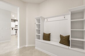 A room with built-in shelving, a bench, and a view into the kitchen area. - Spacious 22-Guest Retreat in Four Corners (Four Corners)