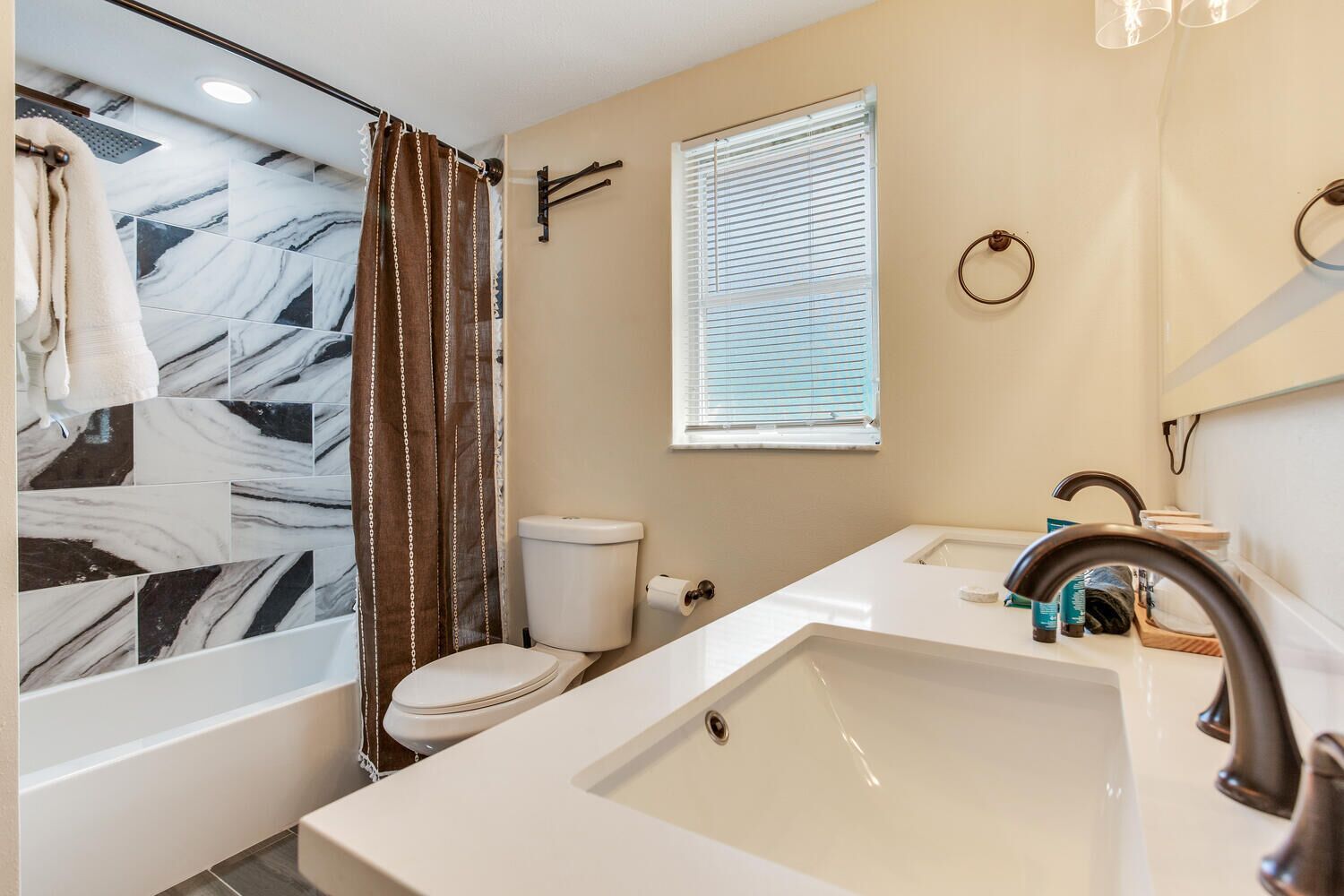 A bathroom with a bathtub, toilet, and sink.
