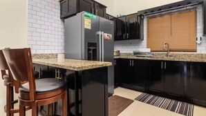 A kitchen with a refrigerator, a sink, and a window with blinds. - 3BR Oasis in Drax hall ~ Pool~ Gym ~ Gated ~Tennis (Saint Ann's Bay)
