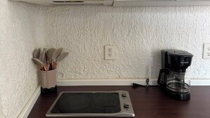 A kitchen with a built-in oven, a coffee maker, and a utensil holder. - Cancun Plaza Caribbean Ocean View & Infinity Pool (Cancún)