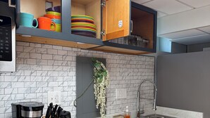 A kitchen with a coffee maker, sink, and cabinets. - Serene 2-bedroom private basement in charming Wentzville (Wentzville)