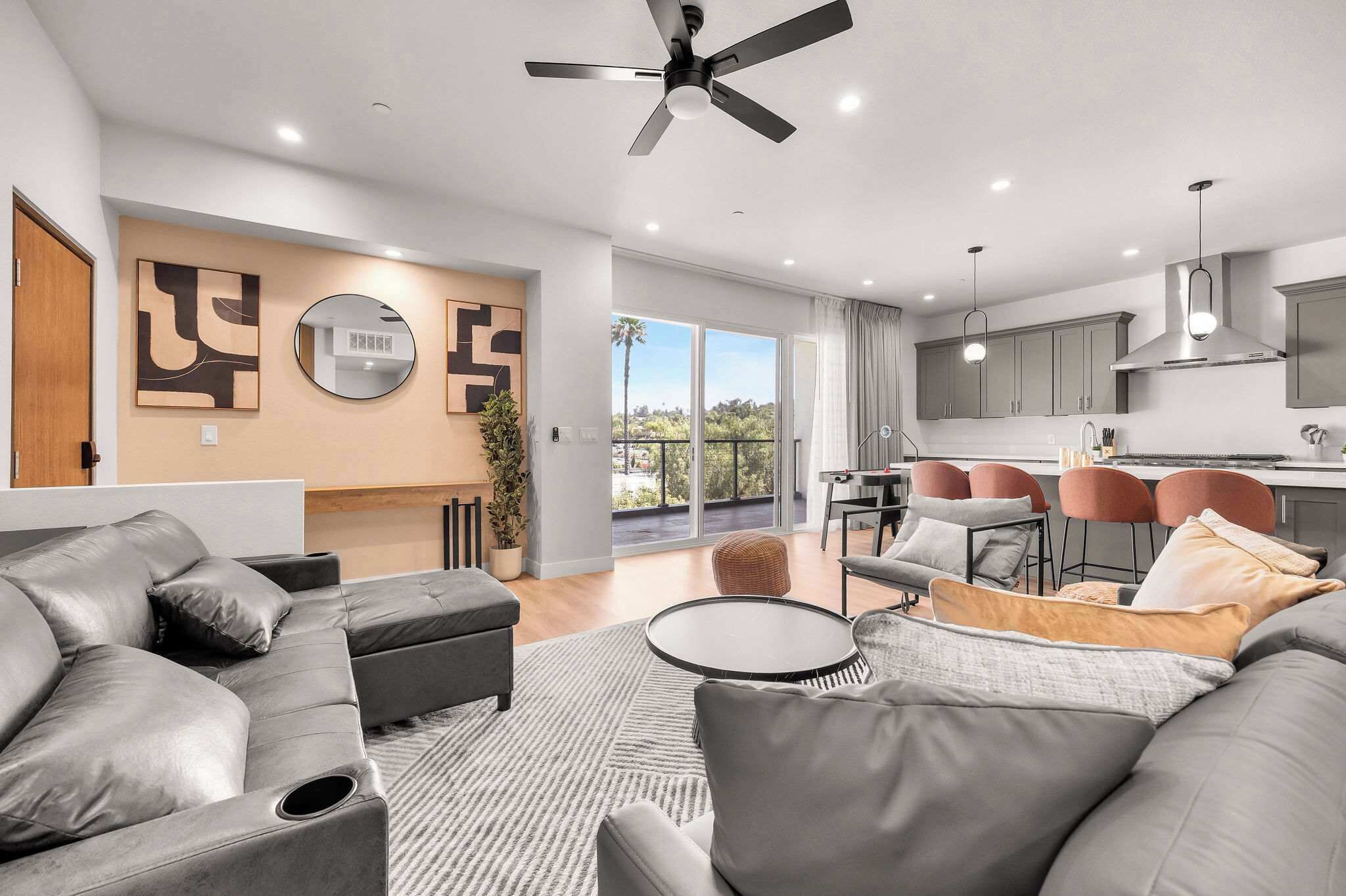 A modern living room with a sofa, a coffee table, and a dining area with chairs.
