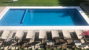 A rectangular swimming pool with a clear blue water surface, surrounded by a white border. - Departamento de Lujo Exclusivo, Vista y Literas. (tlajomulco de zuñiga)