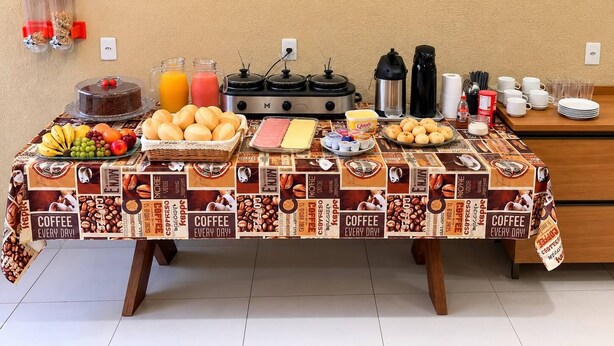 A breakfast buffet with coffee, pastries, and fruit. - HOTEL IDEAL 2 (Inocencia)