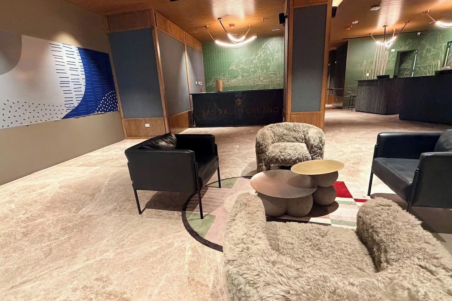 A modern interior with a sofa, armchairs, and a round coffee table.