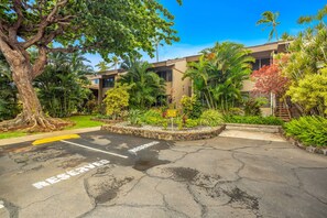 A parking area with a sign indicating reserved parking for unauthorized vehicles. - Beachfront at The Pikake, ocean views (Lahaina)