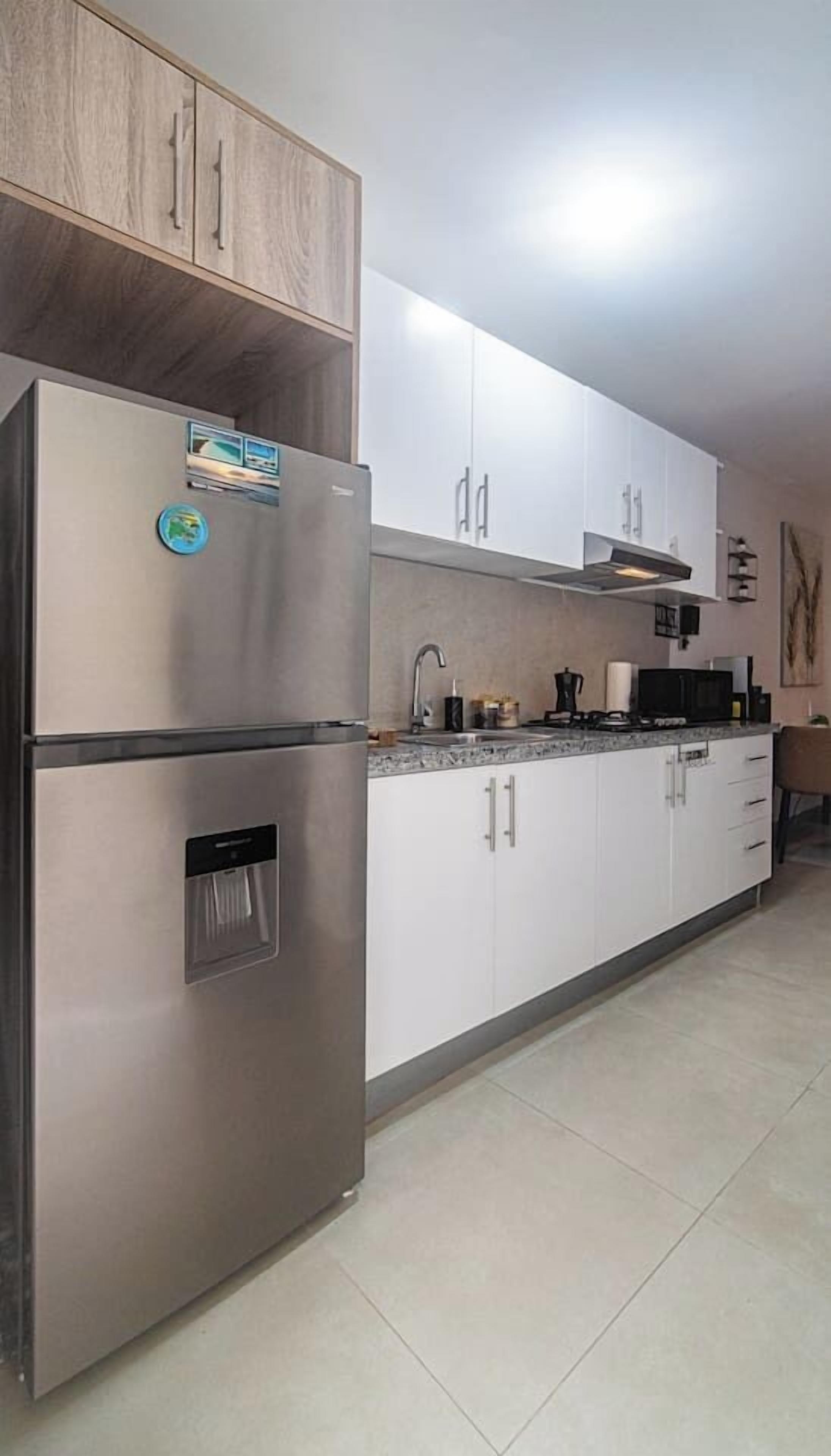 Coffee/tea maker, fridge, dining table