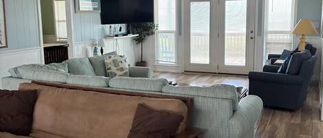 A living room with a brown sofa, a blue armchair, and a wooden coffee table.