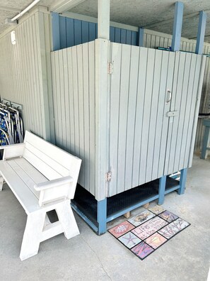 A room with a bench, a door, and a patterned mat. - 3BR Holden Beach retreat with private pool (Holden Beach)
