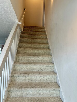 A staircase with a handrail and carpeted steps leading to an upper floor. - 4BR, 4.5BA  Holden Beach home (Holden Beach)