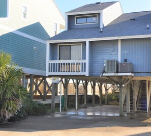 A two-story house with a balcony and an attached air conditioning unit. - Oceanfront 3BR, 2BA Holden Beach getaway (Holden Beach)