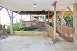 A wooden staircase leading to a covered area with a wooden railing. - Oceanfront 3BR, 2BA Holden Beach getaway (Holden Beach)