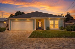 A single-story house with a garage, a front door, and a small front yard. - Caribbean Surf | Private Pool | Beach Access | PCB | Near Beach (Panama City Beach)
