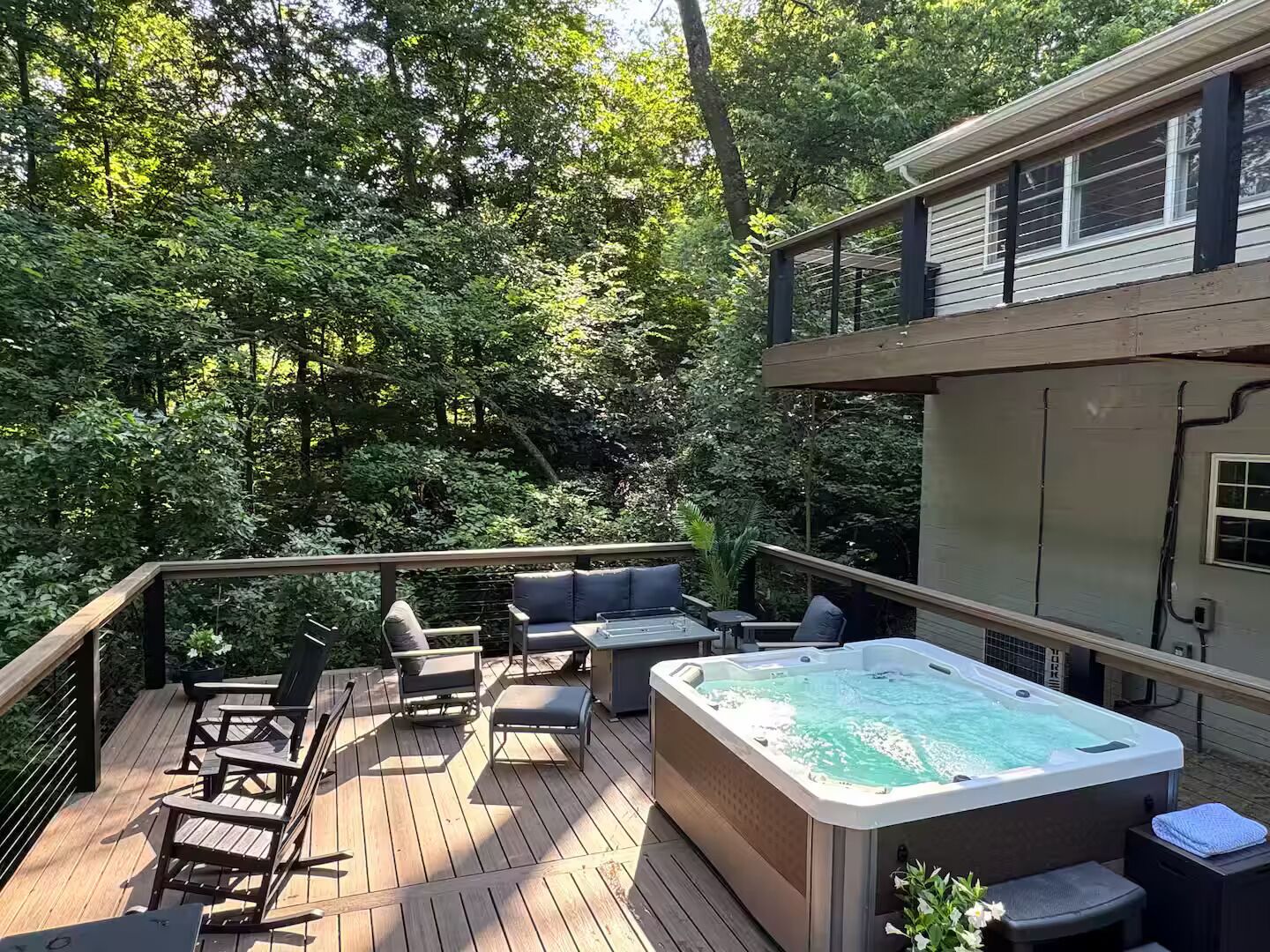 A deck with outdoor furniture and a hot tub.