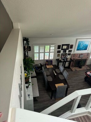 A dining area with a table and chairs, a fireplace, and a large window. - Serene 4-bedroom house in San Diego perfect for your getaway (San Diego)