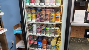 A beverage vending machine stocked with various drinks.