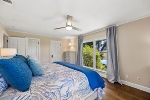 A bedroom with a bed, a ceiling fan, a window with curtains, and a dresser. - Waterfront Amelia Island home with amazing views, deck, parking. (Fernandina Beach)