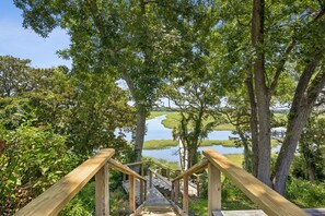 A wooden staircase leading to a viewpoint overlooking a river and a bridge. - Waterfront Amelia Island home with amazing views, deck, parking. (Fernandina Beach)
