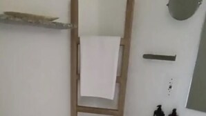 A bathroom with a toilet, a wooden ladder, a sink, a mirror, and a small trash bin. - Santa Marta apartment ocean view 579 a (Santa marta)