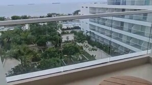 A balcony with a view of a residential area and a body of water. - Santa Marta apartment ocean view 579 a (Santa marta)