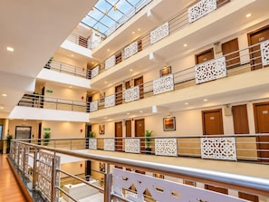 A multi-level hotel interior with balconies, railings, and a central atrium. - Siesta Navi Mumbai (Navi Mumbai)